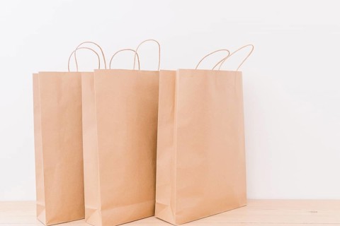 Close up paper shopping bags wooden desk