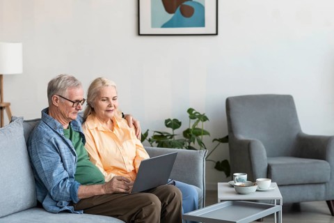Medium shot retired couple with laptop