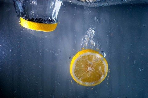 Two slices lemon falling water