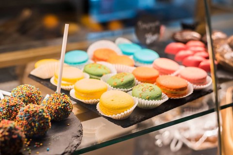 Chocolate cake pops with colorful sprinkles macaroons display cabinet
