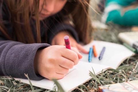 Anonymous girl drawing grass