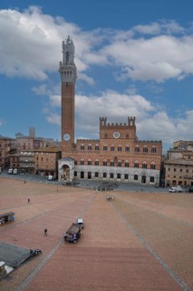 Piazza del Campo at dawn with the bell tower Torre del Mangia and the town hall Palazzo Pubblico