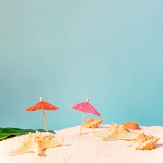 Beach with red sun umbrellas starfishes