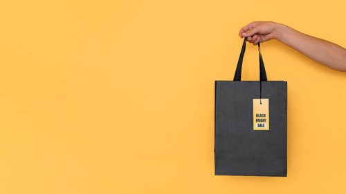 Black friday shopping bag yellow copy space background