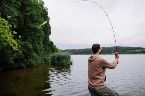 Side view man fishing lake