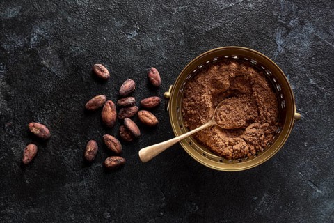 Top view bowl with cocoa powder cocoa beans
