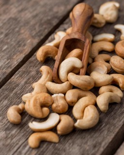 Healthy raw cashew nuts small wooden spoon