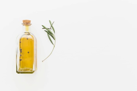Bottle oil with green branch