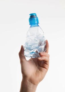 Hand holding plastic bottle