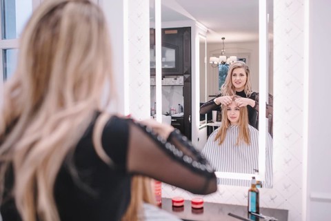Stylist working with girl salon
