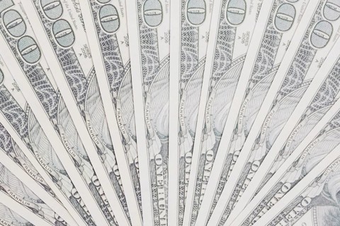 One hundred dollars bills spread out fan shape
