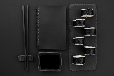 Sushi rolls slate with sauce chopsticks