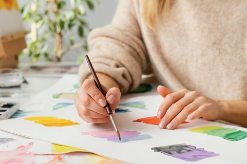 Young woman painting with watercolors
