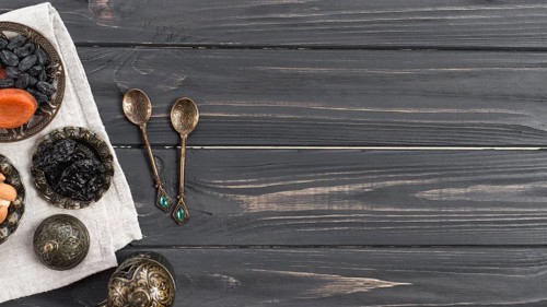 Turkish metallic spoons with dried dates raisin wooden desk