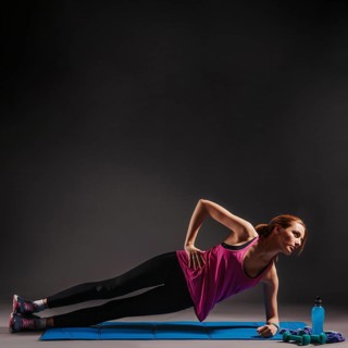 Young woman doing side plank