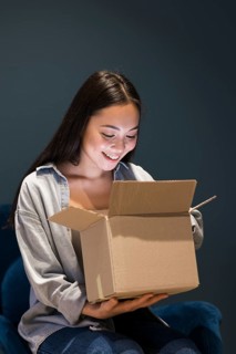 Woman looking box after ordering online