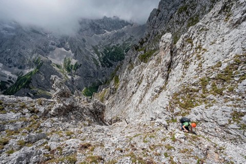 Mountaineer climbing in steep rocky terrain on the way to Waxenstein
