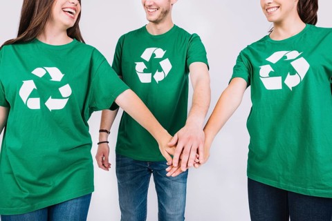 Group friends green t shirt stacking their hands