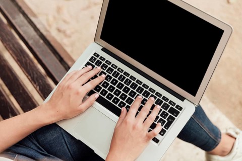 Girl sitting bench with laptop