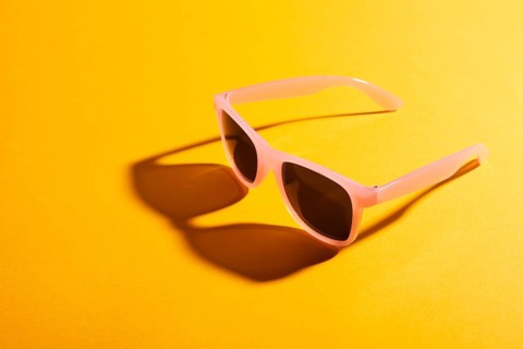 Close up colored sunglasses with shadow