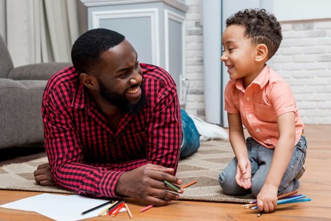 Black father son with pencils floor