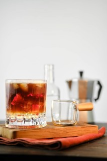 Hot espresso coffee in glass with cold tonic and ice