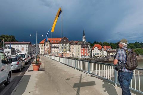 Flag-decorated bridge over the Isar with Gewiierhimmel