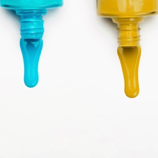 Top view spilled nail polish white backdrop