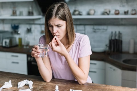 Woman having fever taking medicine home