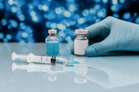Syringe vaccine bottle table with hand glove