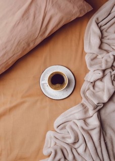 Top view morning coffee cup bed