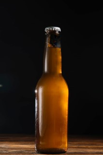Close up beer bottle wooden desk