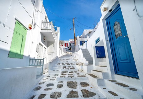 Cycladic white houses with colourful shutters and doors
