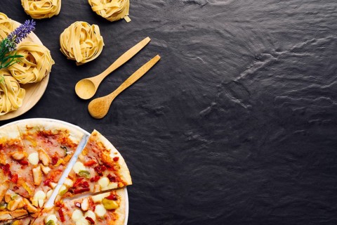 Italian food composition with pizza space right