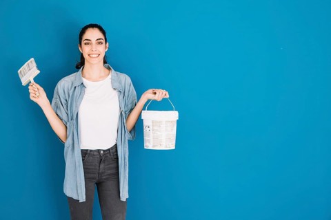 Woman holding brush bucket