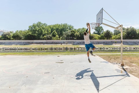 Basketball player throwing basketball hoop