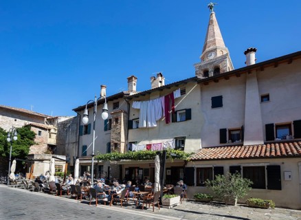 Restaurant in the old town with the Basilica of Sant Eufemia
