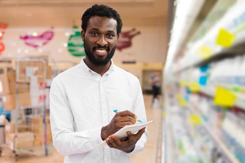 Man checking off items shopping list