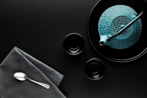Flat lay crockery with teapot silver spoon