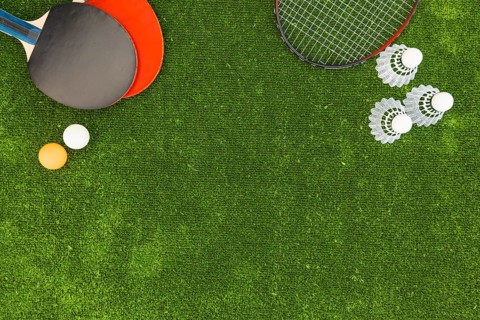 Ping pong balls shuttlecock badminton rackets green turf