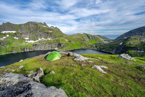 Green tent in the mountains