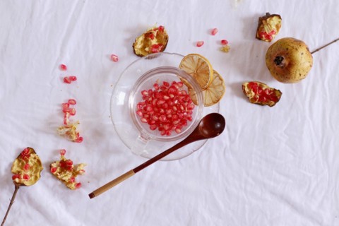 Overhead view of pomegranate fruit and dried lemon slices for making fresh juice