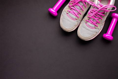 Top view arrangement with pink shoes dumbbells