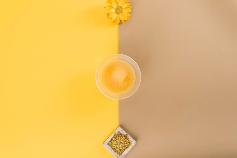 Elevated view flowers lemon curd bee pollen dual colored background