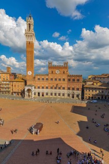 Spring clouds over the Piazza del Campo with the bell tower Torre del Mangia and the town hall Palazzo Pubblico