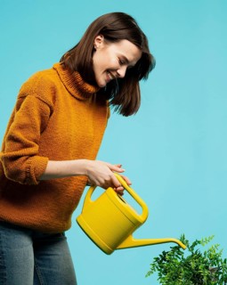 Medium shot woman with watering can