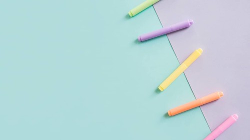 Multi colored markers grey green paper background