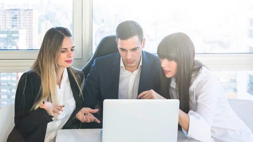 Business people looking laptop having discussion meeting