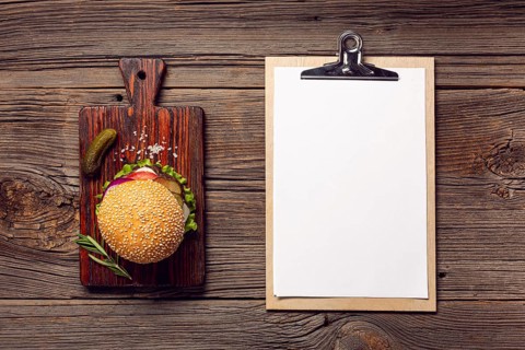 Flat lay burger with mock up clipboard