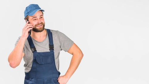Man overall talking by phone